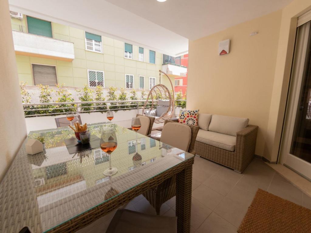 a balcony with a glass table and chairs at The Best Rent - Modern apartment close to Sant'Agnese Metro Station in Rome