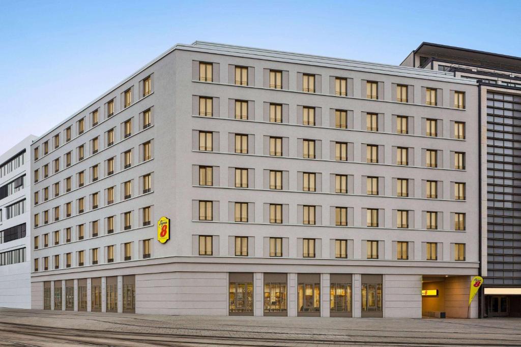 a large white building with many windows at Super 8 by Wyndham Chemnitz in Chemnitz