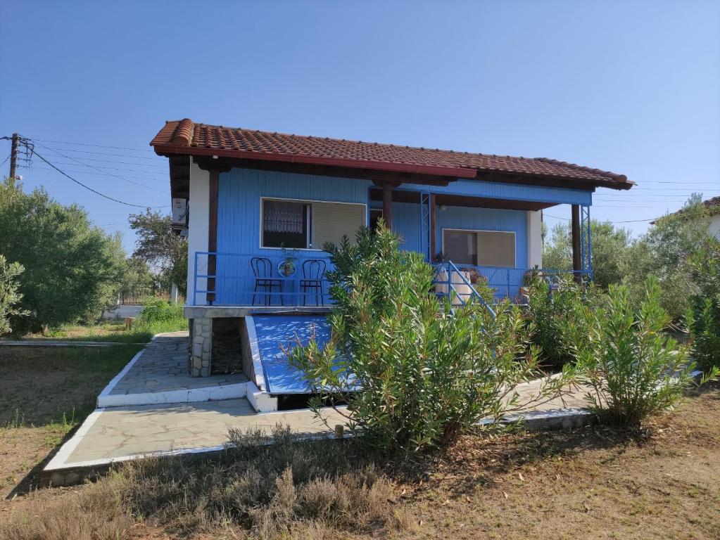 a small blue house with a porch at Spitaki in Epanomi