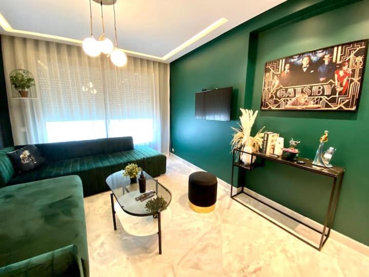 a green living room with a couch and a table at Anfa Living 29-The Gatsby 5 Chic&New Apt near Sea in Casablanca