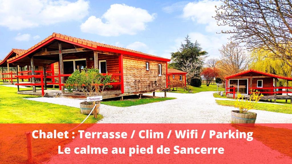 a small wooden cabin with a red roof at LES CHALETS DE SANCERRE in Thauvenay