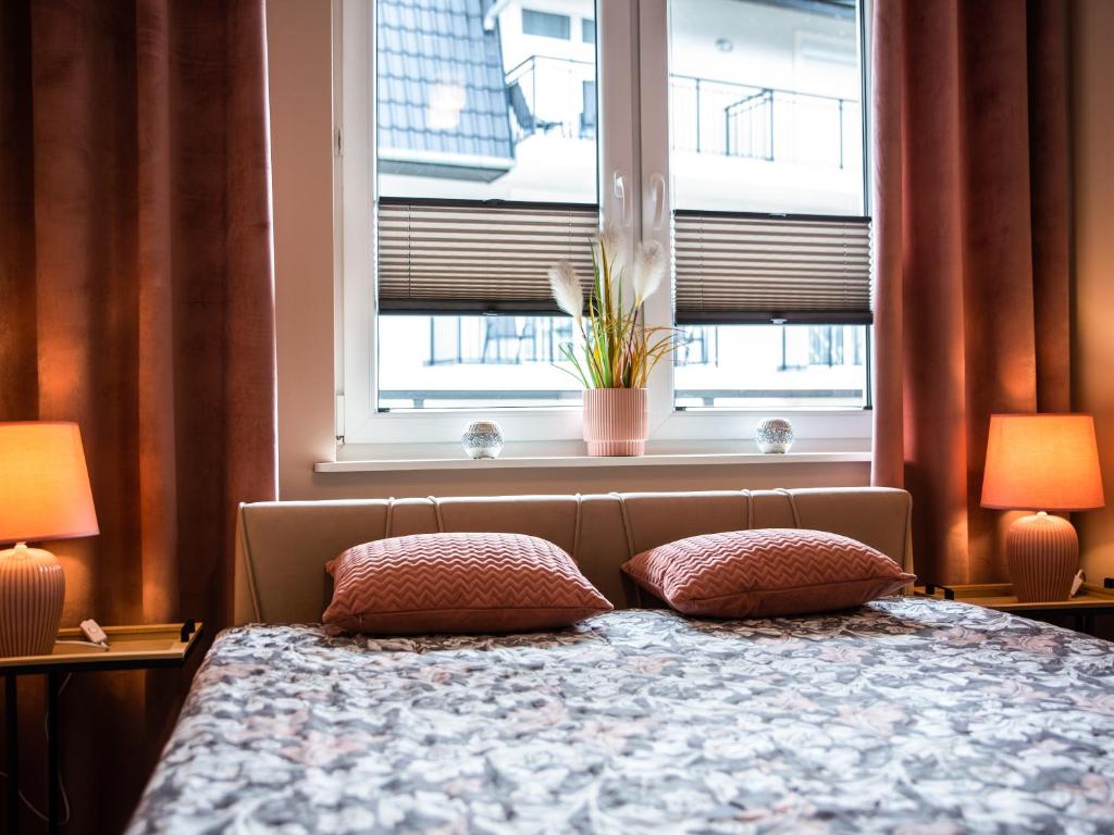 Posteľ alebo postele v izbe v ubytovaní Markowe Apartamenty Złoty Park