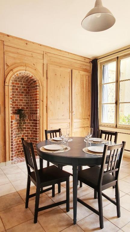 une salle à manger avec une table et des chaises noires dans l'établissement Le 2 pièces avec parking privé, à Honfleur