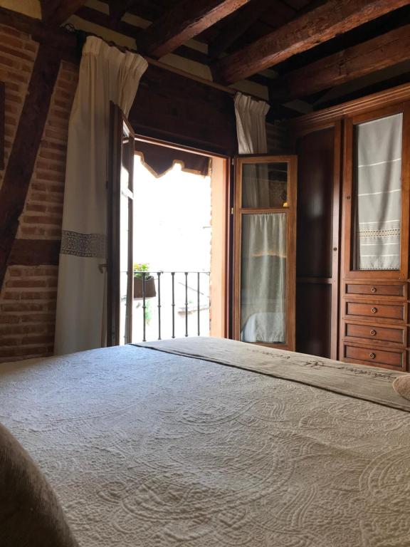 Postel nebo postele na pokoji v ubytování Hospederia Casa de Cisneros