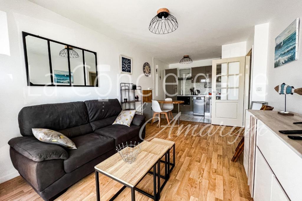 a living room with a couch and a table at A 2 PAS du PORT in Saint-Valéry-sur-Somme