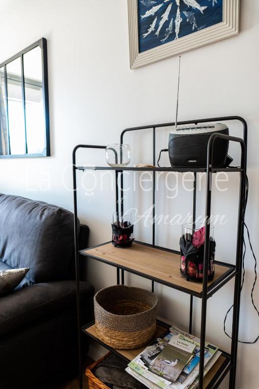 a living room with a black shelf and a couch at A 2 PAS du PORT in Saint-Valéry-sur-Somme