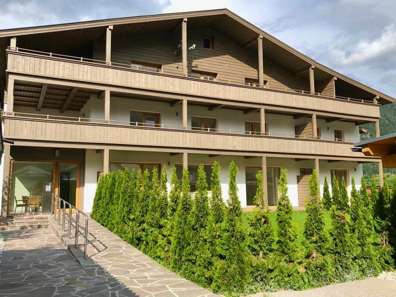 a building with a bunch of bushes in front of it at Christinenhof Top 5 mit großem Balkon in Lofer