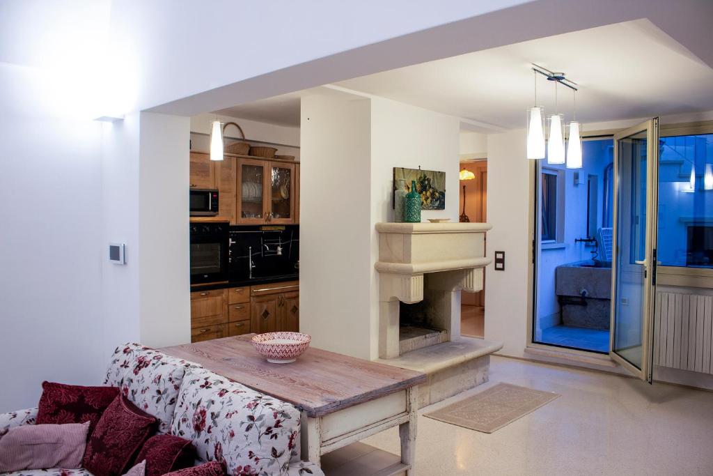 a living room with a table and a fireplace at Amata Casa in Muro Leccese