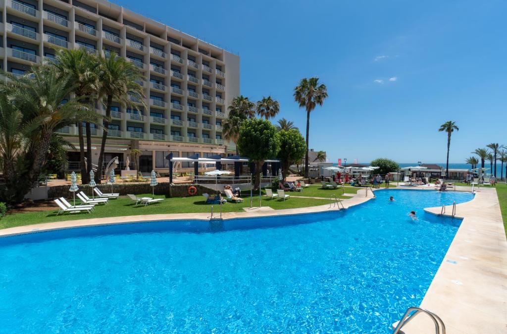 a large swimming pool in front of a hotel at Medplaya Hotel Pez Espada in Torremolinos