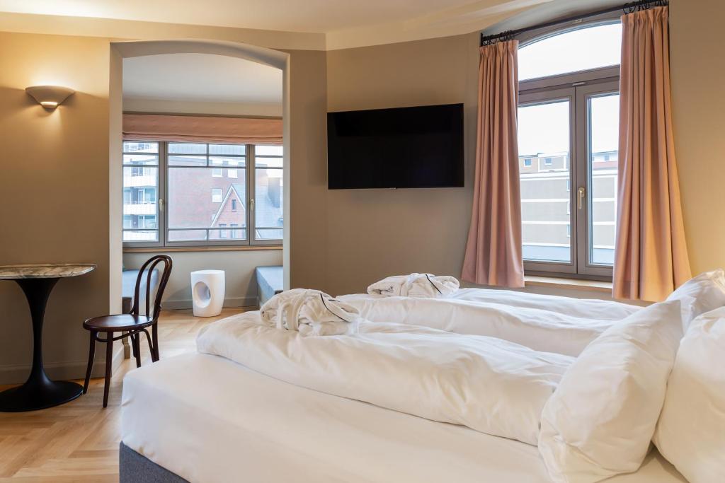 Postel nebo postele na pokoji v ubytování Mimosa Suites