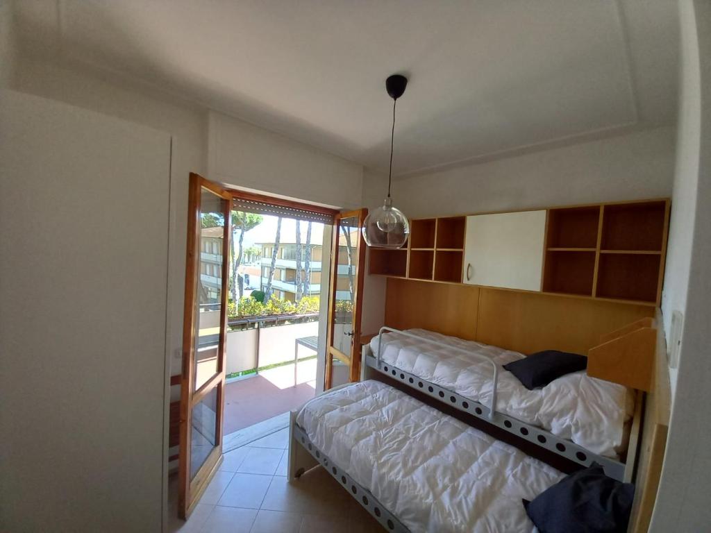 Posteľ alebo postele v izbe v ubytovaní Carachouse-Lido di Camaiore, tra pini marini e mare