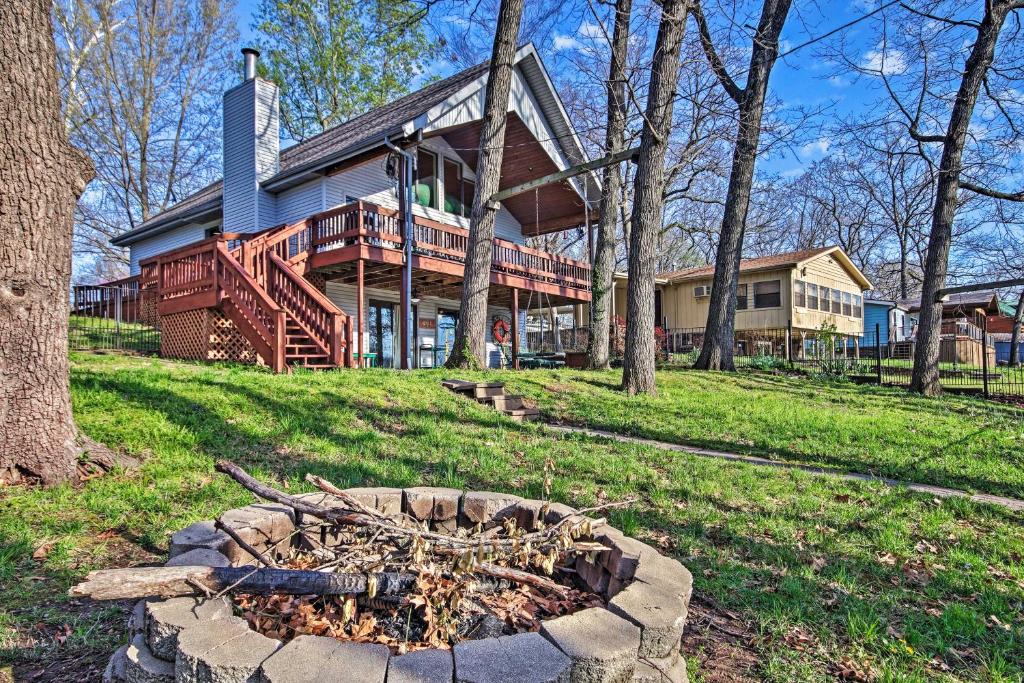 a house with a fire pit in front of it at Fire Pit and Boat Slip Waterfront Grove Getaway in Grove