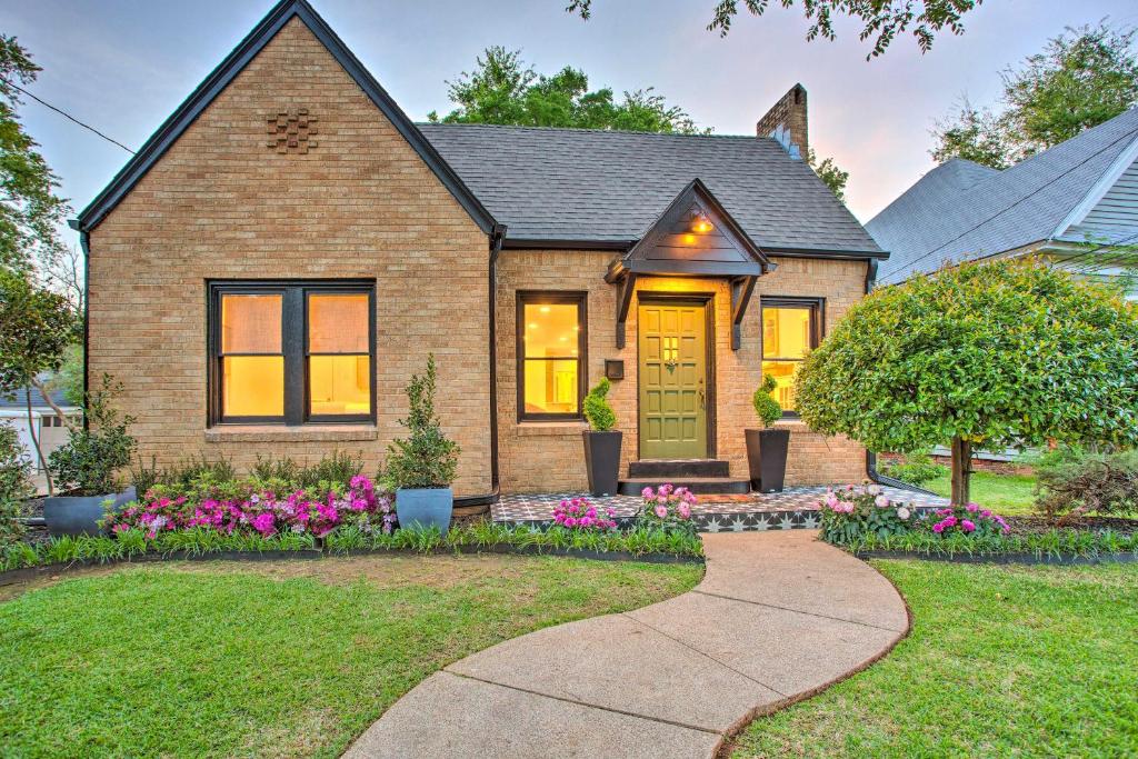 a brick house with a front door and flowers at Newly Updated and Charming Azalea District Home in Tyler