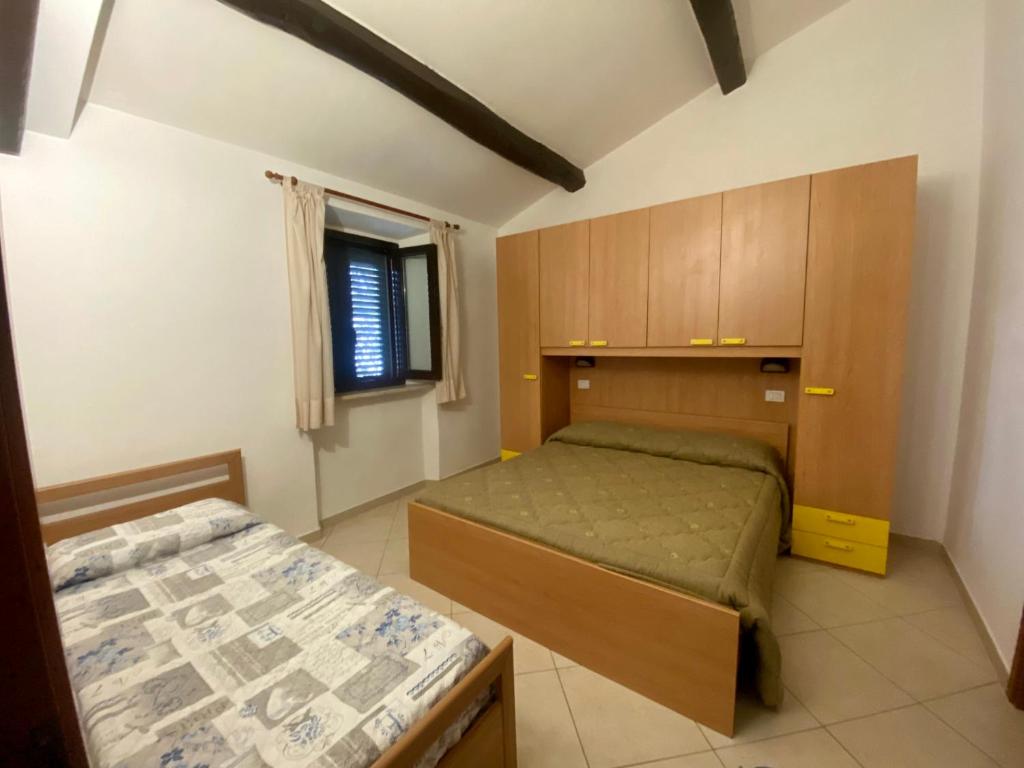 Postel nebo postele na pokoji v ubytování Il Tombolo