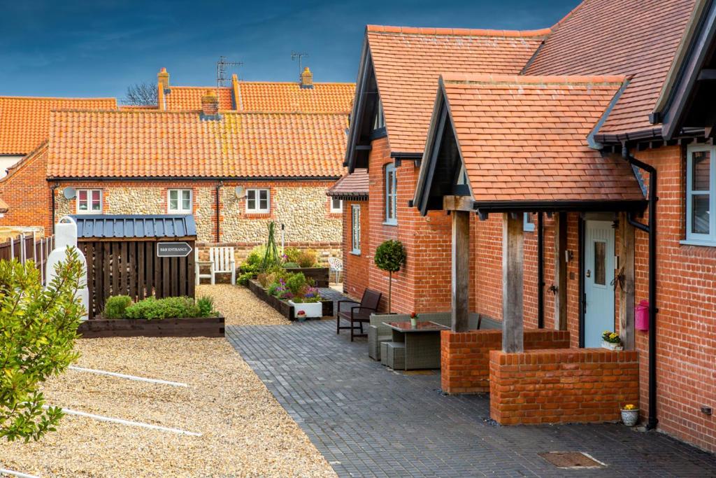 a row of brick houses with a courtyard at Little Regent Hall in Sheringham