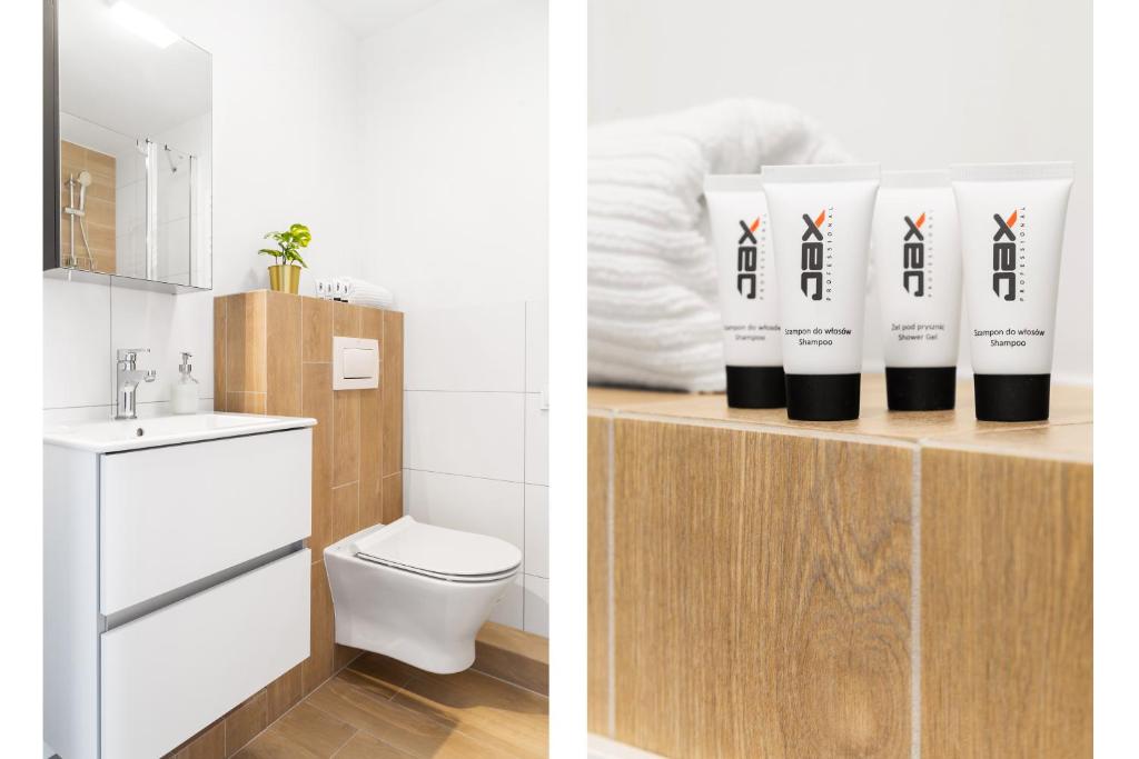 a bathroom with a toilet and towels on a shelf at Lumen Studio in Wrocław