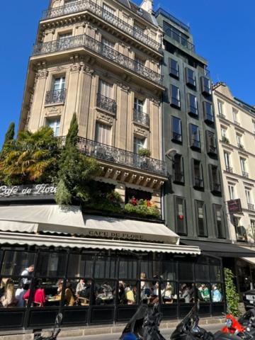 ein hohes Gebäude mit einem Uhrturm davor in der Unterkunft Magic suite in Saint Germain des Près (Montana5) in Paris