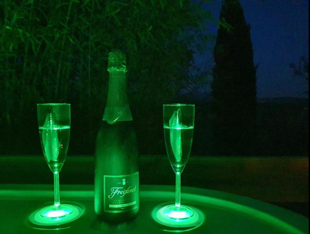 a bottle of champagne and two glasses on a table at Adorable chalet avec jacuzzi privatif in Aix-en-Provence