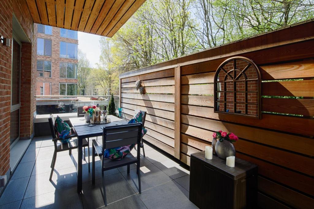 a patio with a table and chairs and a fence at Springfield Four in Harrogate