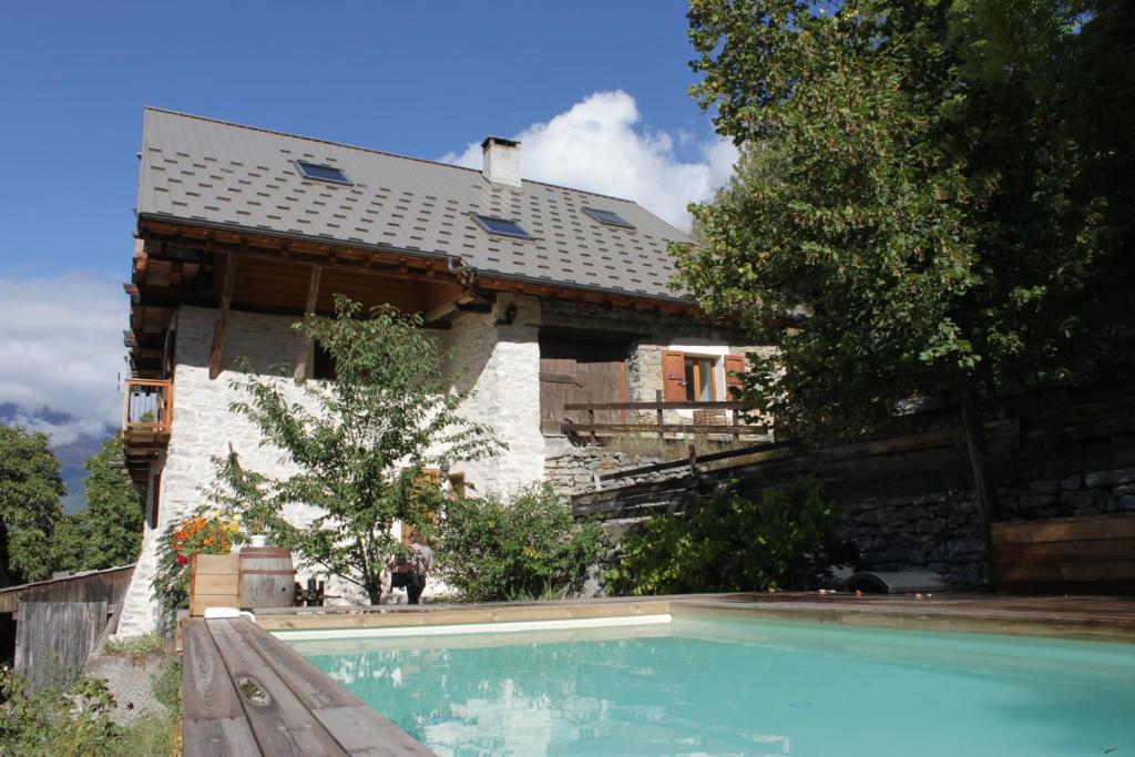 ein Haus mit einem Pool vor einem Haus in der Unterkunft L'Eyssart in Les Vigneaux