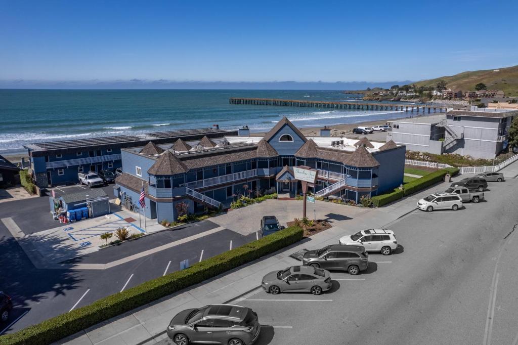a street with cars parked in front of a beach at Shoreline Inn...on the beach in Cayucos