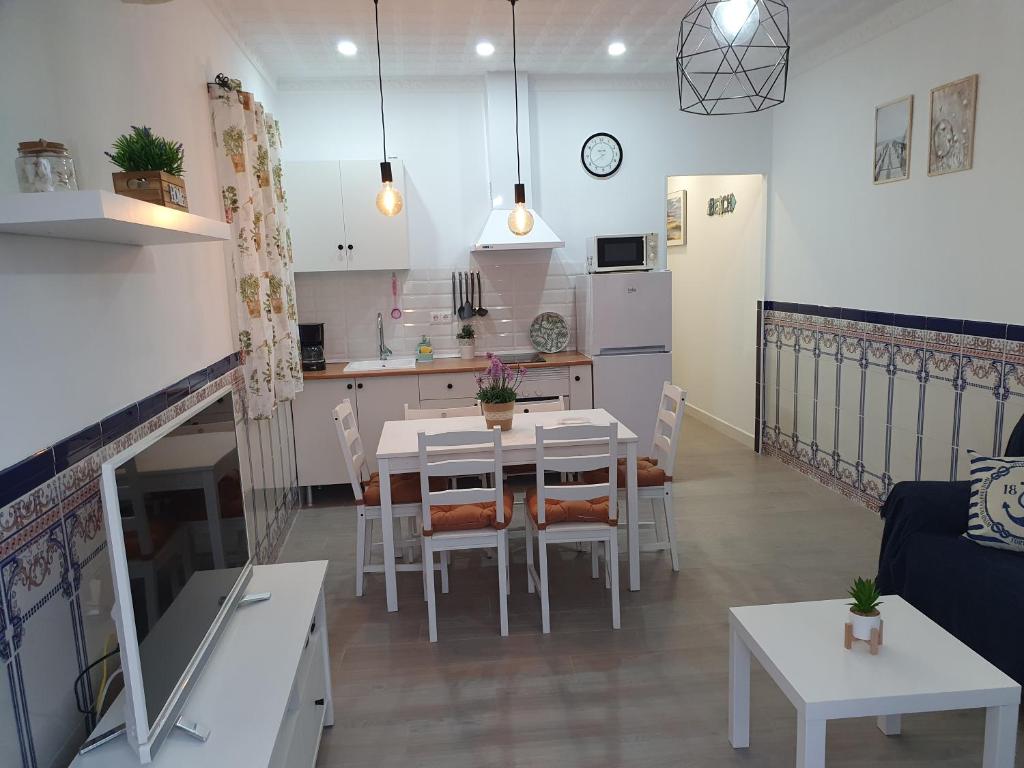 a kitchen and a living room with a table and chairs at Brisas del mar in Caleta De Velez