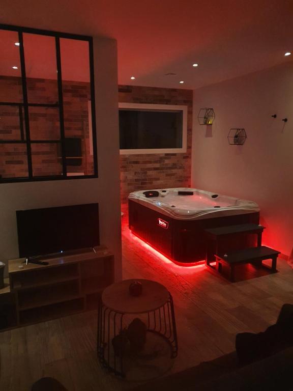 a living room with a pool table with red lights at Instant secret in Pourrières