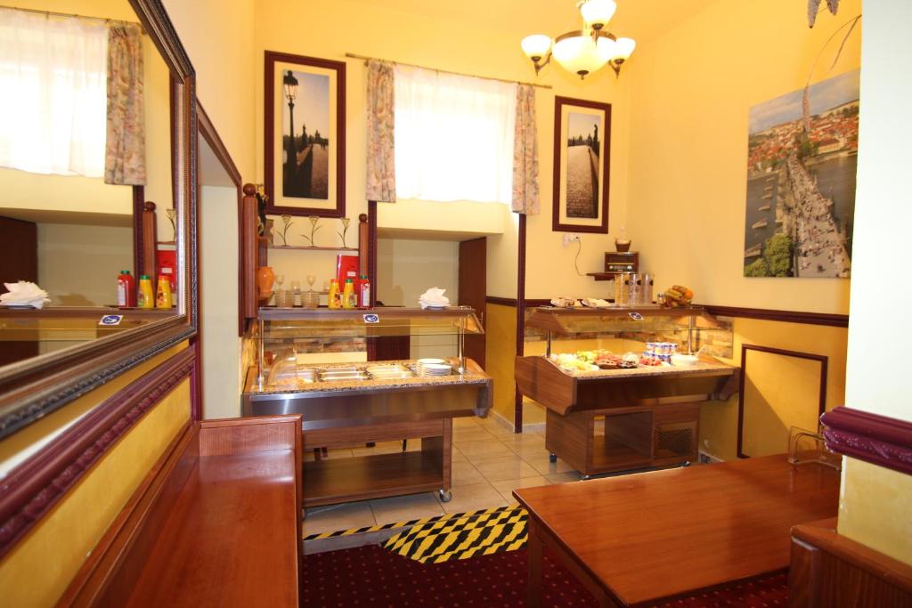a room with a restaurant with two sinks and a table at Old Prague Hotel in Prague
