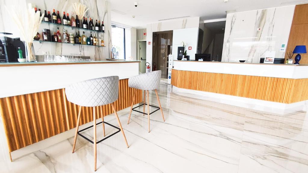 a bar with two stools at a counter at Catania Sea Palace Hotel in Catania