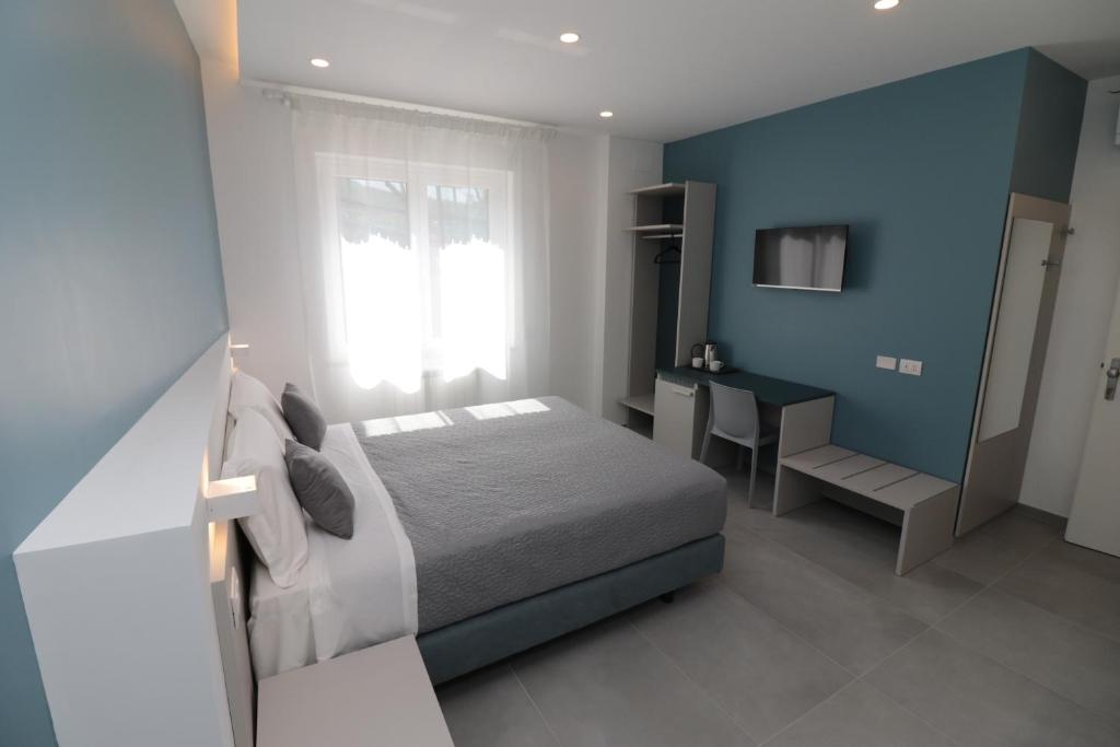 Łóżko lub łóżka w pokoju w obiekcie Maison Nanà