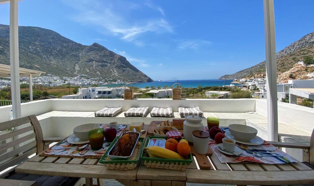 a table with food on top of a balcony at Alkyonis Sunset Suite in Kamares