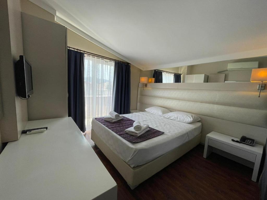 a hotel room with a bed and a window at Gold Butik Otel in Marmaris