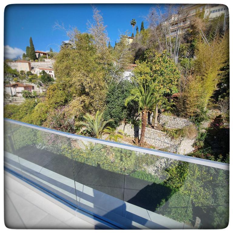 a view from a train window of a road with trees at Le Vallaya Suites & Spa in Menton