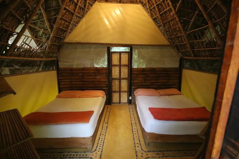 a bedroom with two beds in a room at Aldea Huasteca in El Platanito