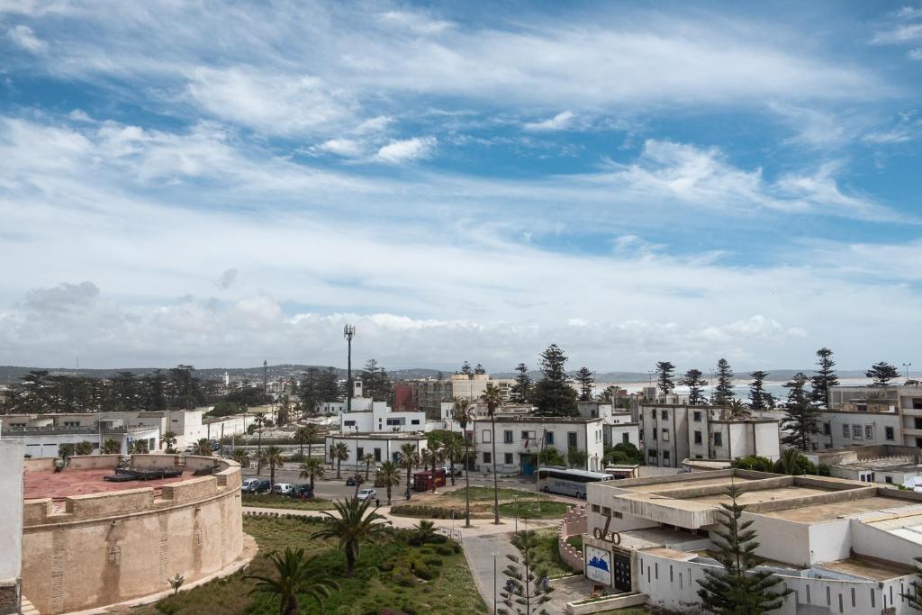 a view of a city with buildings and palm trees at Noqta Space Coworking Coliving Space in Essaouira