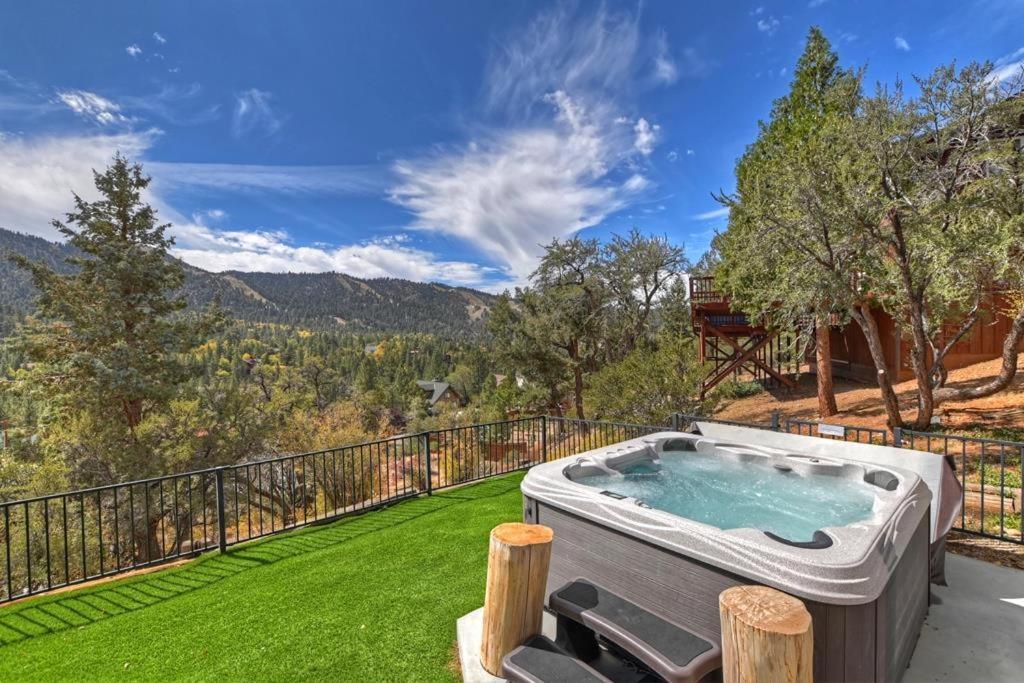 a hot tub on a balcony with a view of the mountains at 053 - Glass House on the Ridge in Big Bear Lake