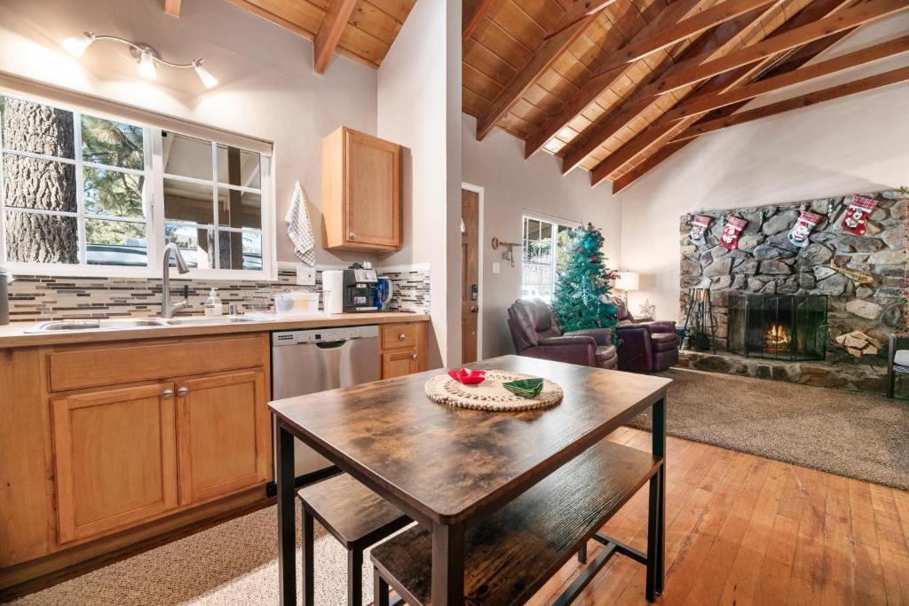 a kitchen with a wooden table in a room at 060 - The Angeles Chalet in Big Bear City