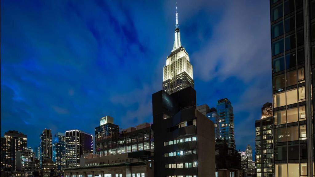 a view of the empire state building at night at Best Western Premier Empire State Hotel in New York