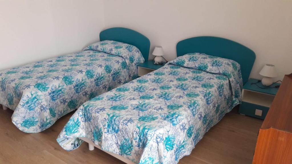 Posteľ alebo postele v izbe v ubytovaní Pecciolo Port Apartaments