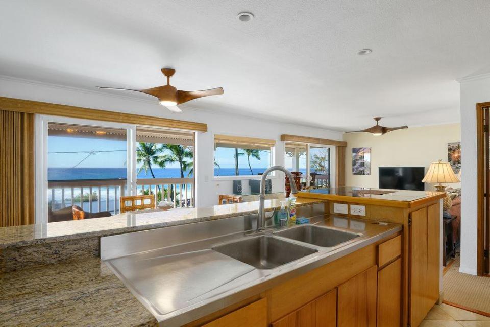 a kitchen with a sink and a view of the ocean at Ocean View 2 Bedroom Kahalu'u Reef in Kailua-Kona