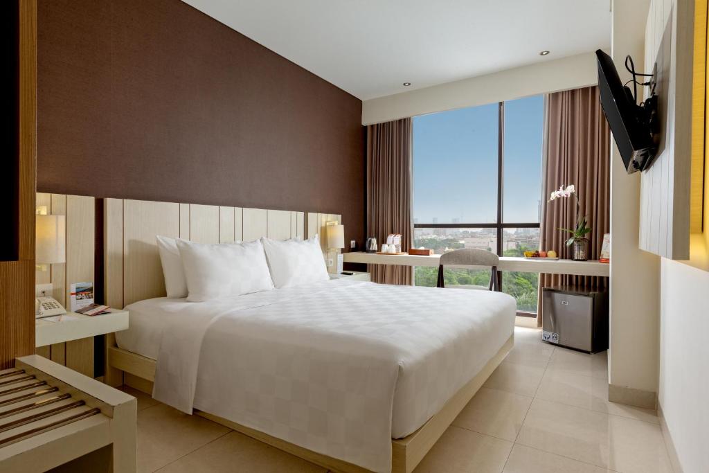Postel nebo postele na pokoji v ubytování Swiss-Belinn Gajah Mada Medan