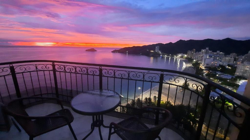 a balcony with a view of the ocean at sunset at El Peñon del Rodadero - Apto 1303A in Santa Marta