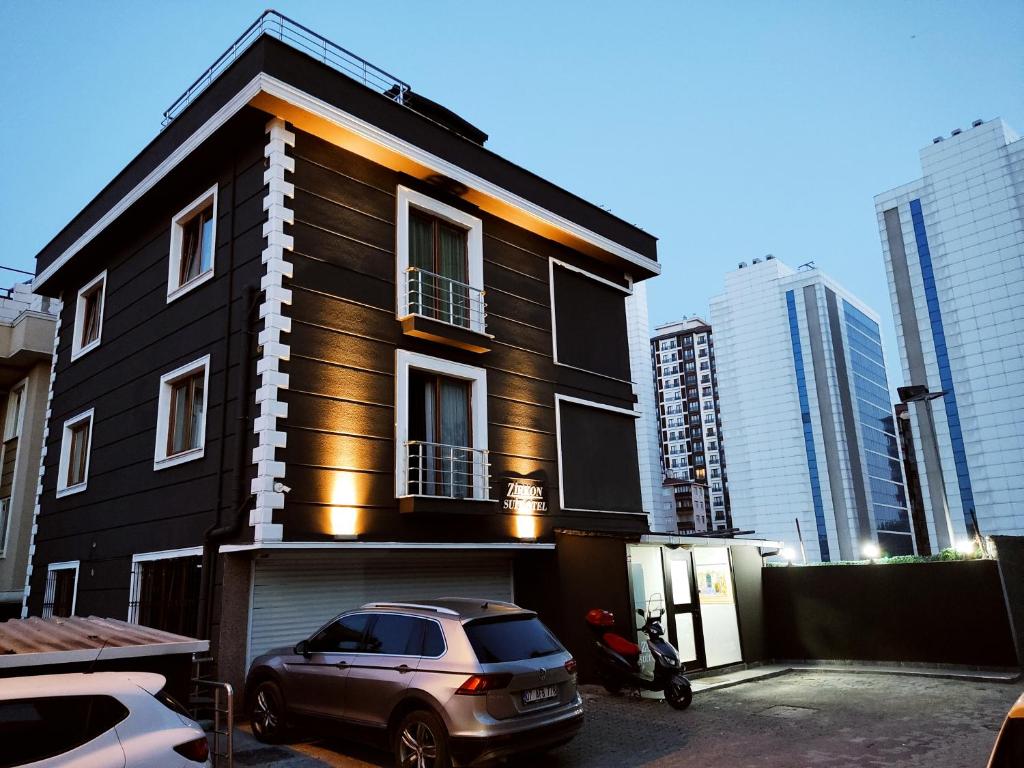 a black house with a car parked in front of it at Zirkon Suit, Atasehir Otel, in Istanbul