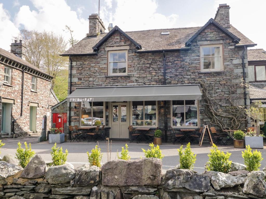 a building with a stone wall in front of it at The Bakers Loft in Ambleside