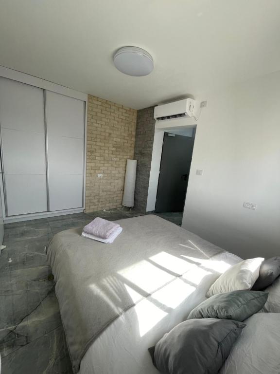 a bedroom with a large bed in a building at SEA& SUN in H̱adera
