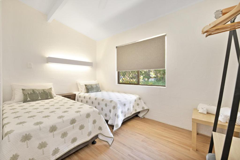 Postel nebo postele na pokoji v ubytování Kinka Palms Motel