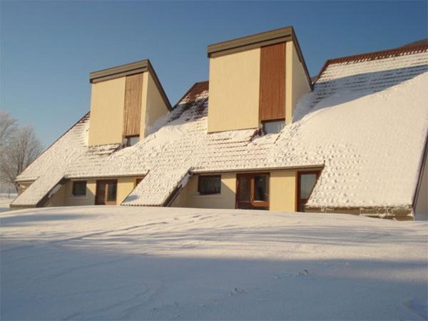 a house covered in snow with a roof at Le Piroulet in Vassieux-en-Vercors