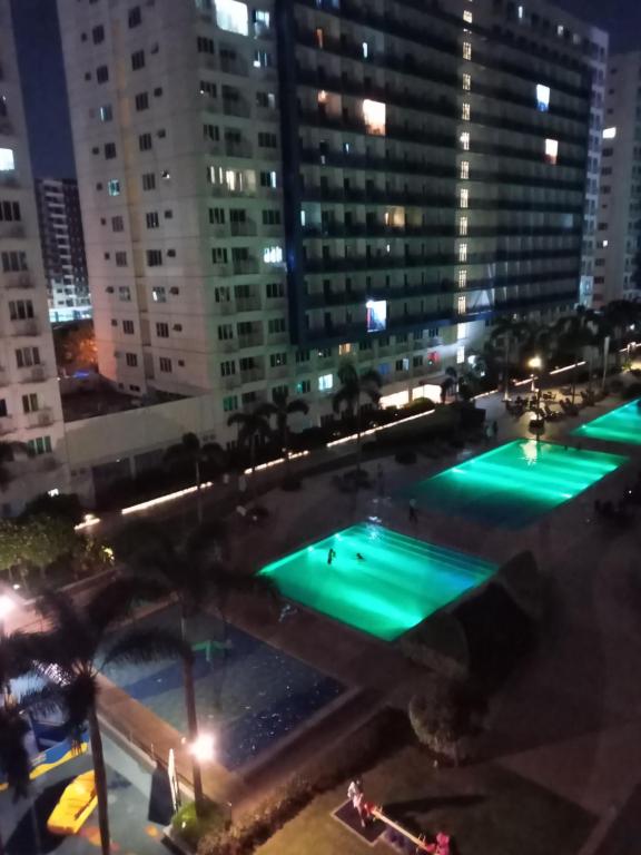an overhead view of a swimming pool at night at LIAM's Staycation in Manila