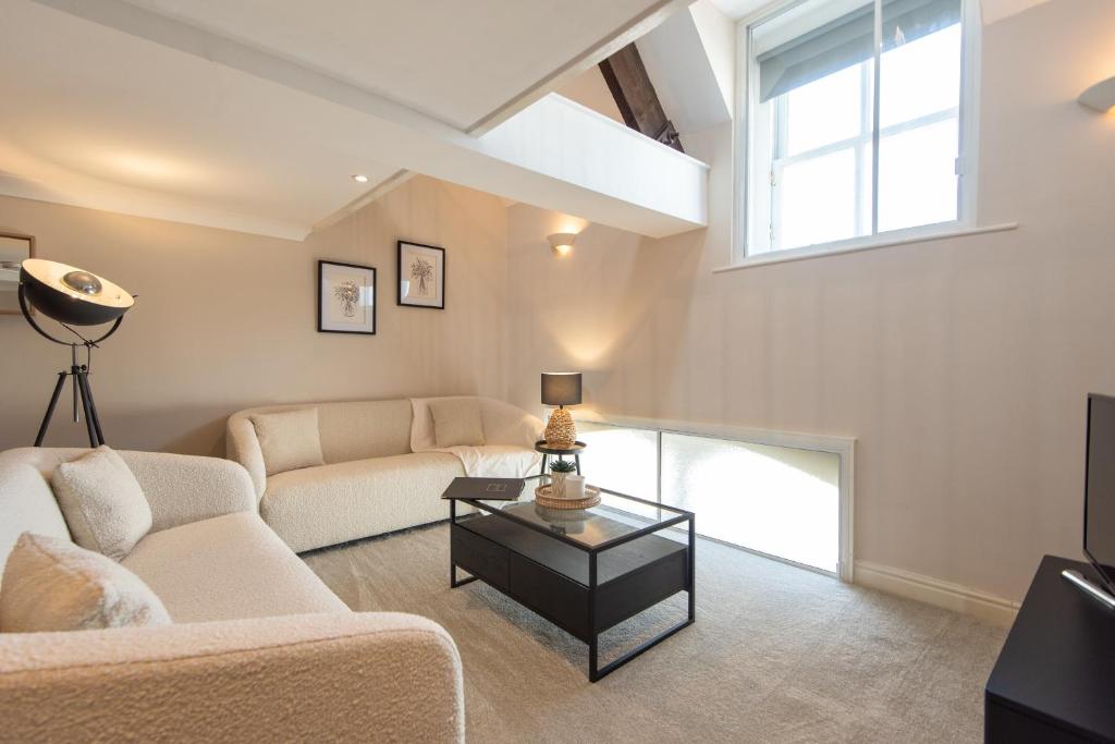 a living room with a couch and a table at St Andrews Court in Durham