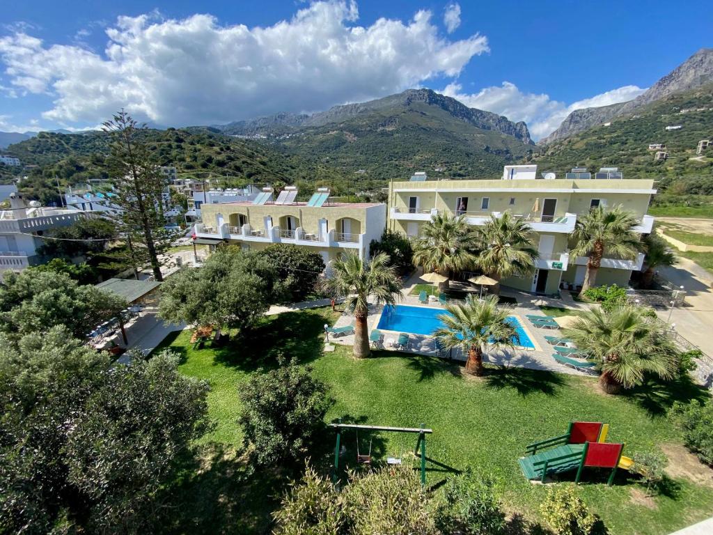 an aerial view of a resort with a swimming pool at Manolis Apartments plakias in Plakias